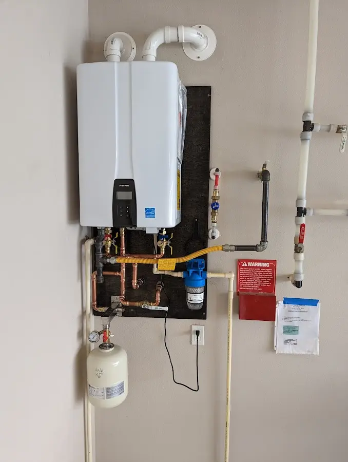 Professional plumber installing copper piping in a Plymouth home